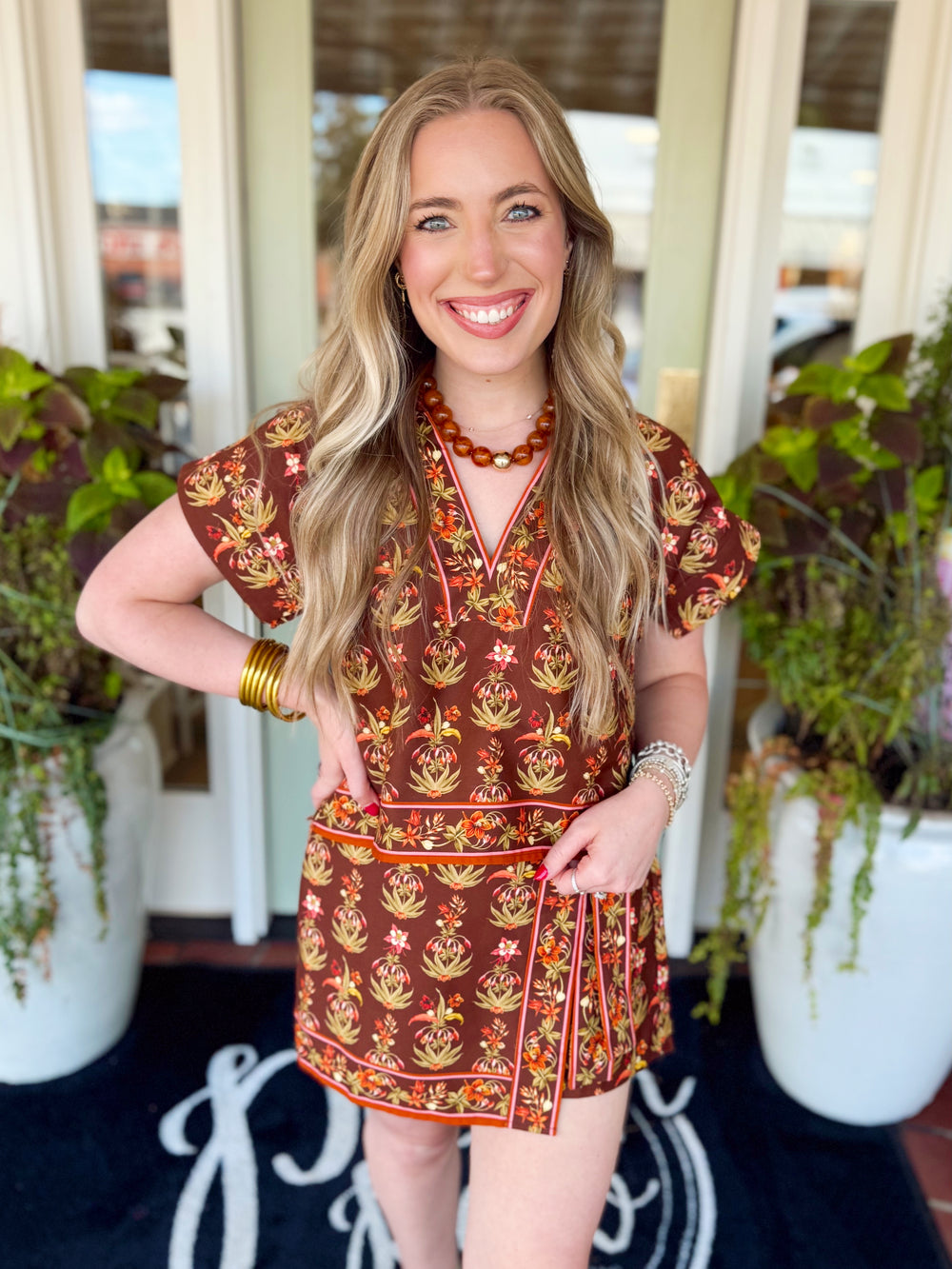 This lightweight short sleeve top features an allover floral print with contrast border trim for an extra pop of interest.
