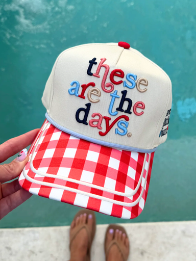 Cap with 'these are the days' text and red checkered bill against a teal background