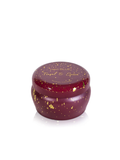 A small round metal tin with a dark red lid and body, decorated with scattered gold leaf flakes. The lid features gold foil text that reads 'TINGEL & SPICE' and 'CINHA DILIJES'.