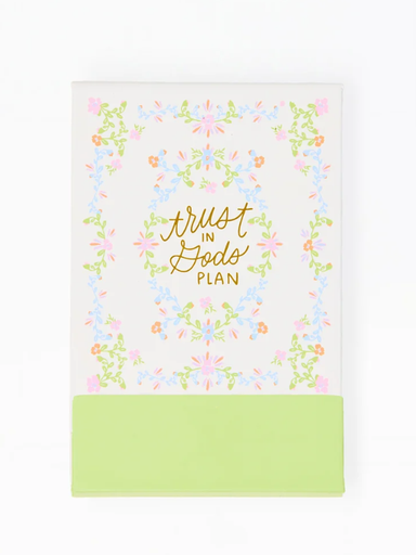 Notebook with 'Trust in God's Plan' text and floral design on a white background