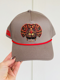 red and brown turkey fanned out on a dark tan hat