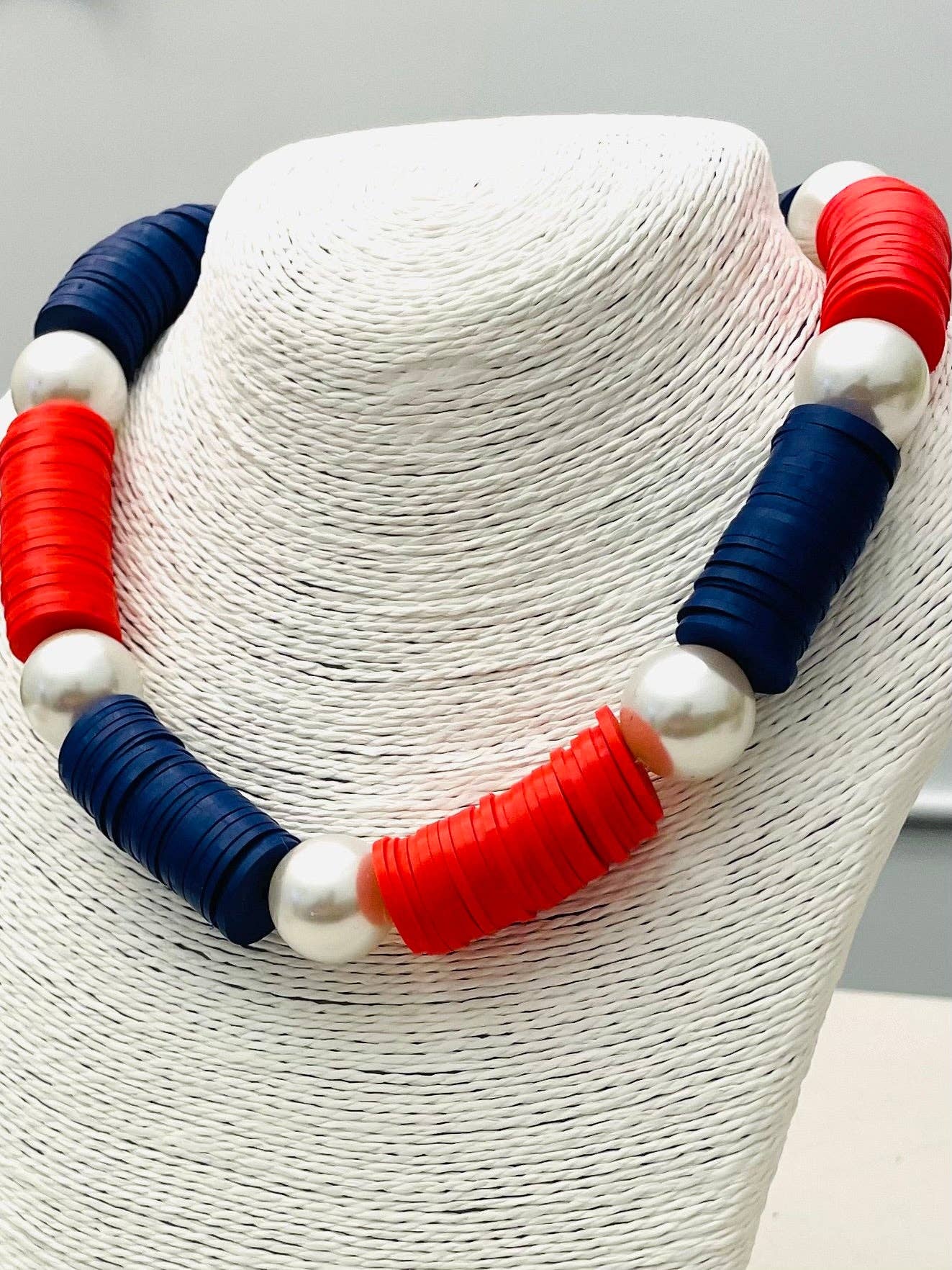 clay disk necklace and red and blue and pearl