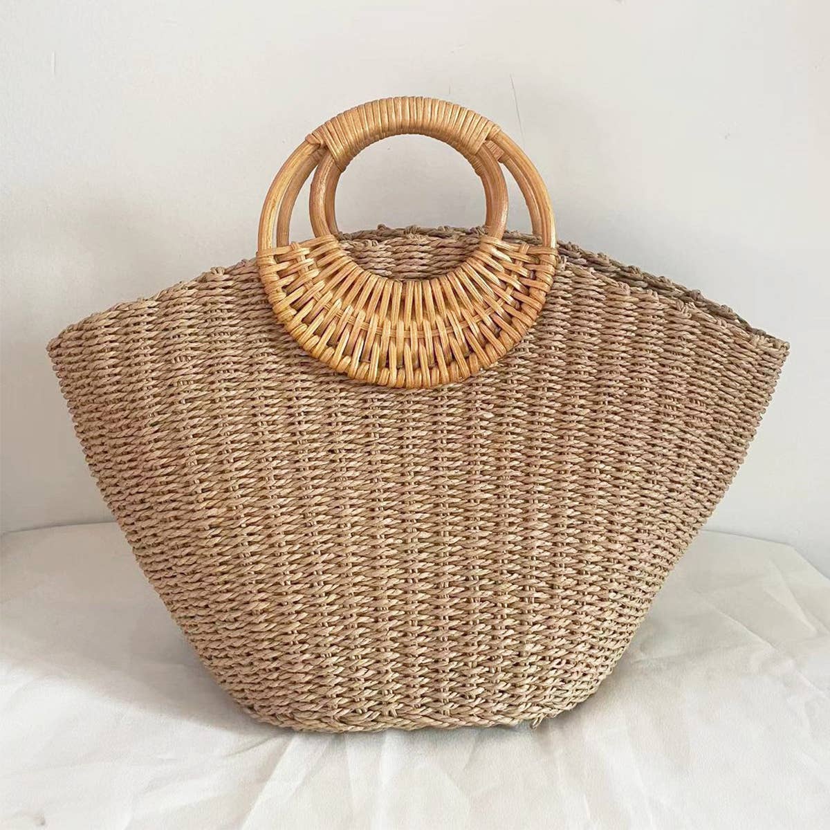 Woven rattan handbag with circular wooden handles