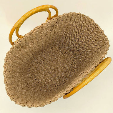 Brown textured handbag with wicker handle 