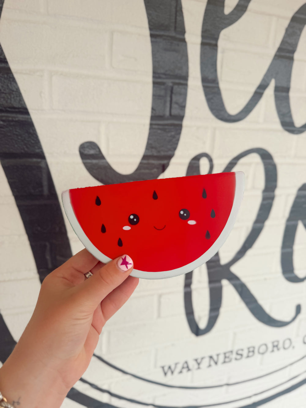 Cute watermelon slice foam squishy toy with a smiling face and soft slow-rising texture for stress relief and sensory play.