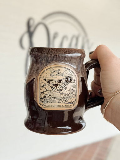Brown coffee mug with a drippy look at the narrow rim with a bird dog on the front 