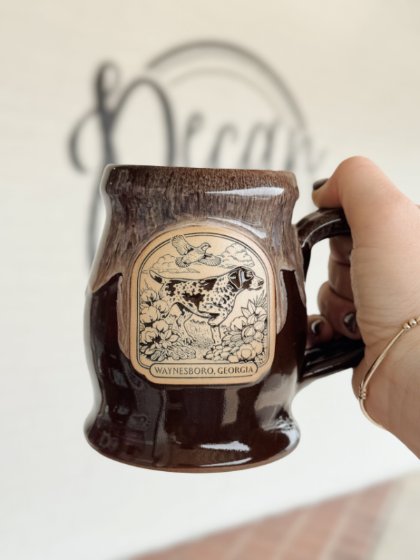 Brown coffee mug with a drippy look at the narrow rim with a bird dog on the front 