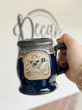 blue coffee mug with a froty narrow rim with a bird dog on it 
