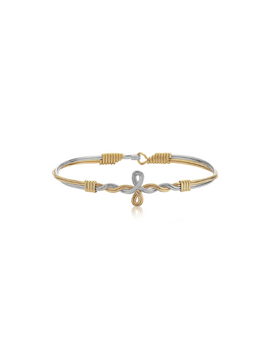 Two-tone gold and silver bracelet with a knot design on a white background