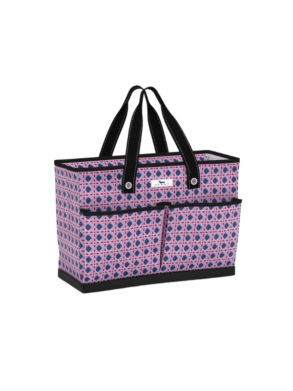A tote bag with a pink and blue geometric pattern, black handles, and black trim