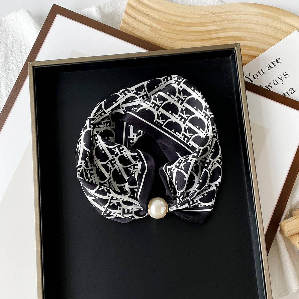 Black and white patterned scarf with a pearl center clasp 
