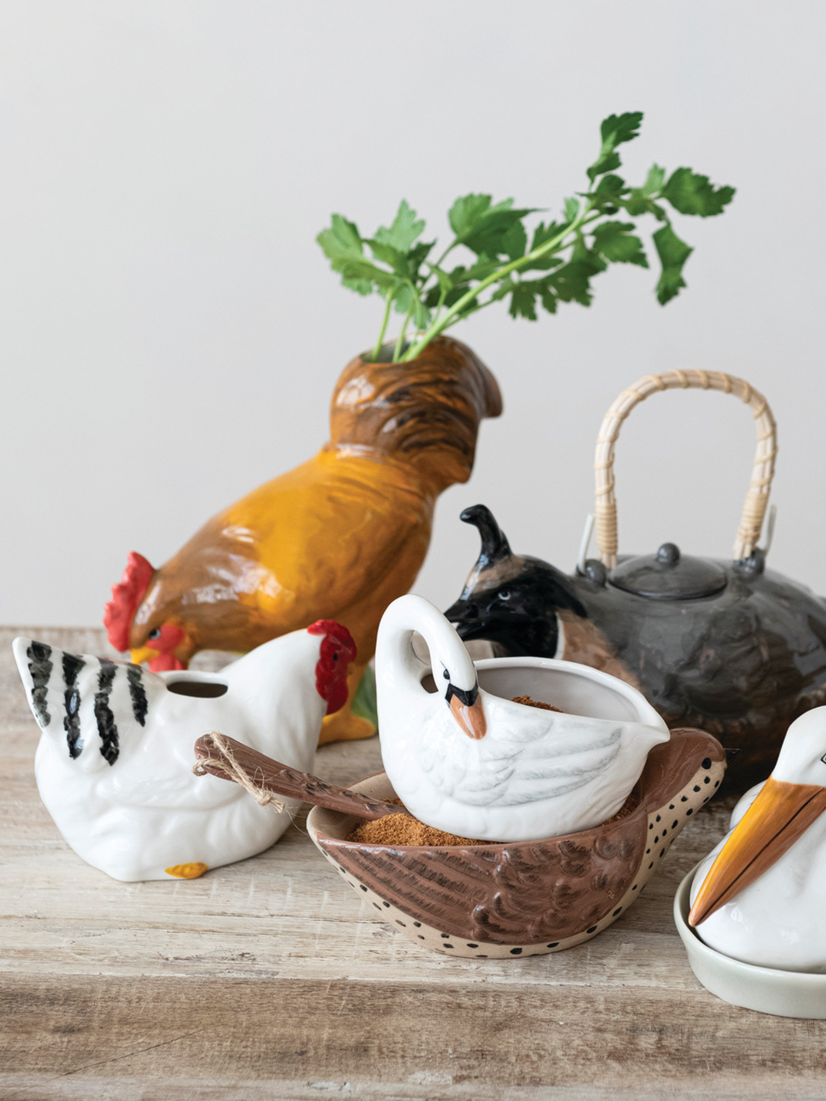 White ceramic hen vase with red comb and black feather accents