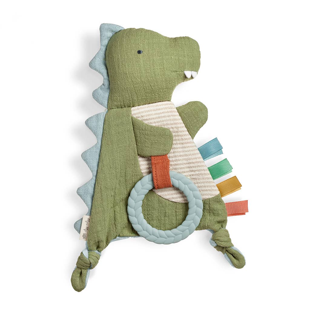Green dinosaur-shaped toy with a teething ring on a white background