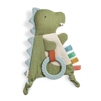 Green dinosaur-shaped toy with a teething ring on a white background