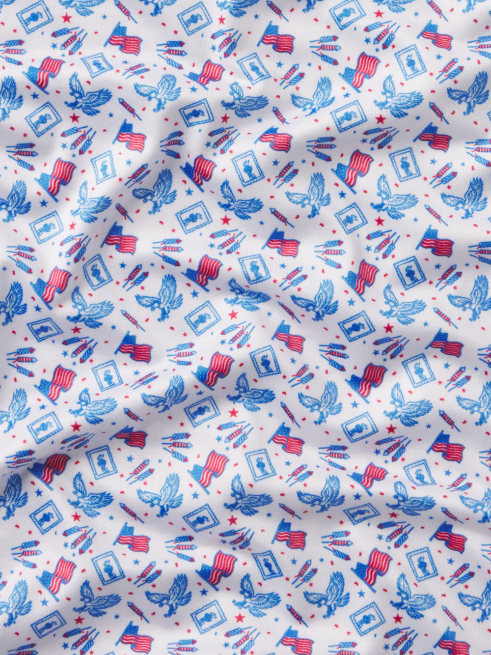 Fabric with red, white, and blue pattern featuring eagles and flags on a white background