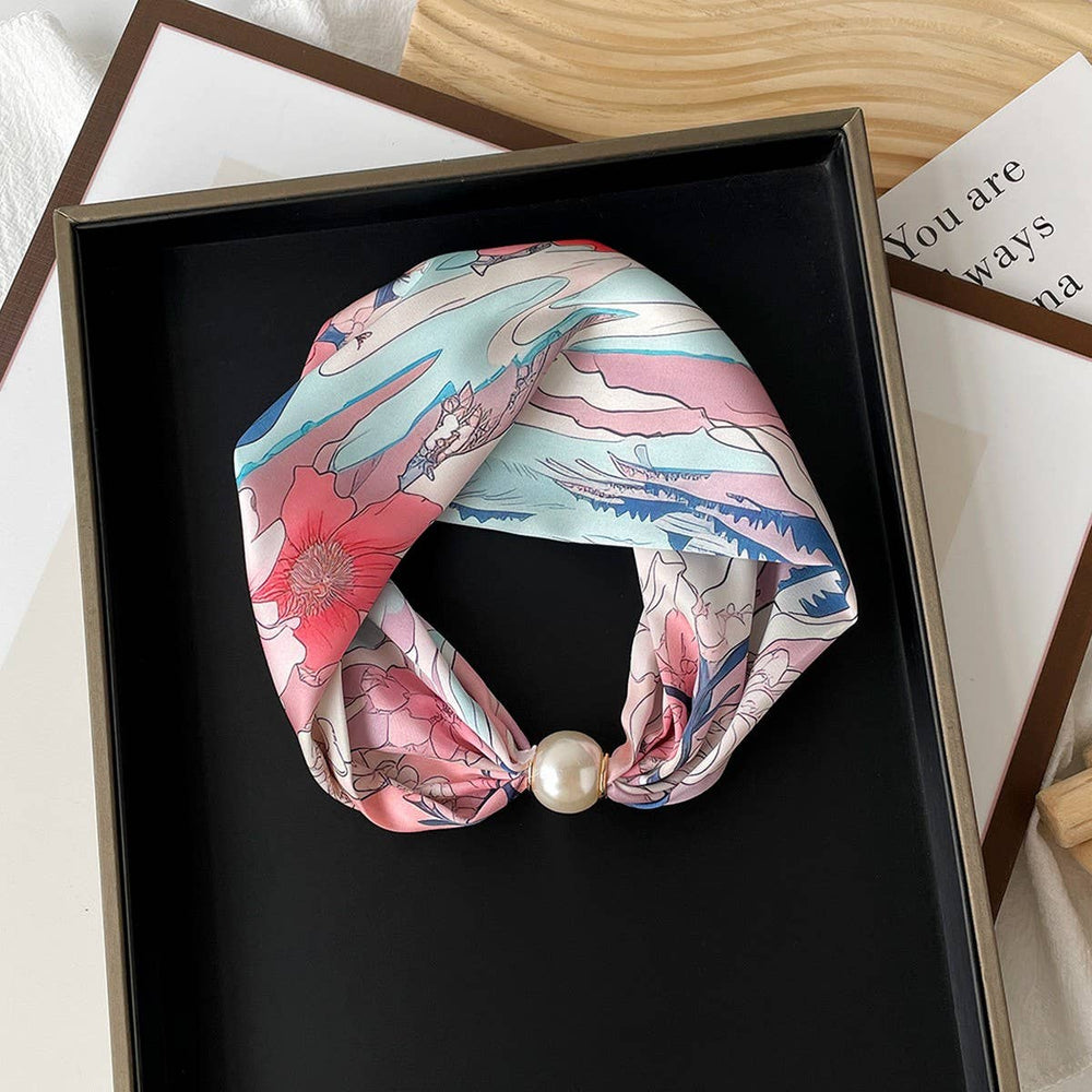 Decorative headband with floral design and pearl accent 