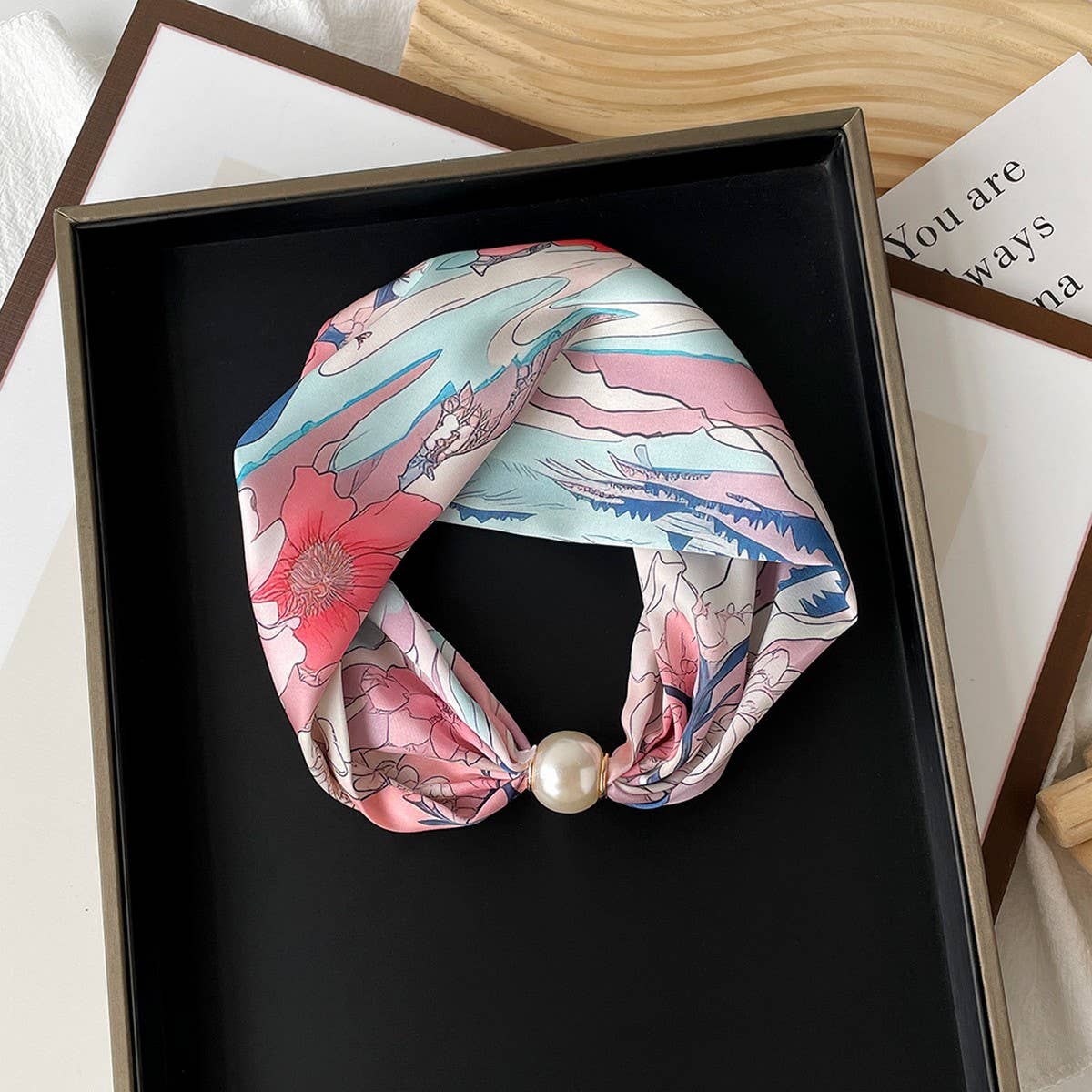 Decorative headband with floral design and pearl accent 