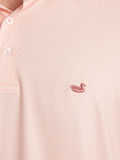Close-up of a coral polo shirt with a small logo on the chest and shell pattern 
