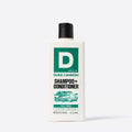 Duke Cannon shampoo and conditioner bottle on a white background