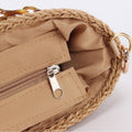 Close-up of a beige woven bag with a zipper 